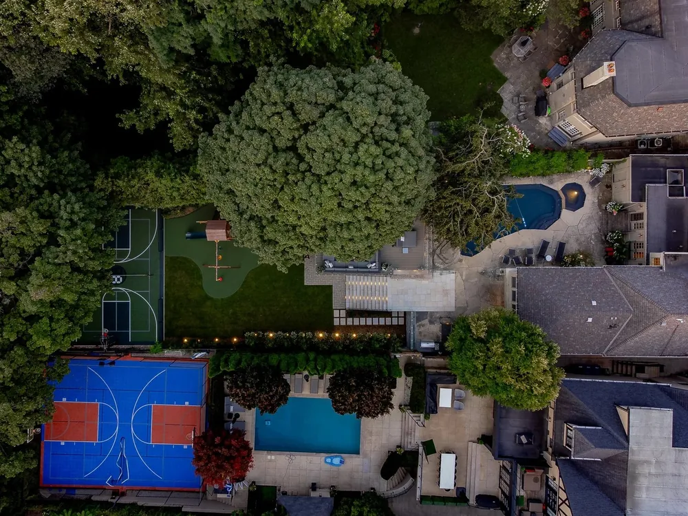 Top-down aerial of pool and sport court